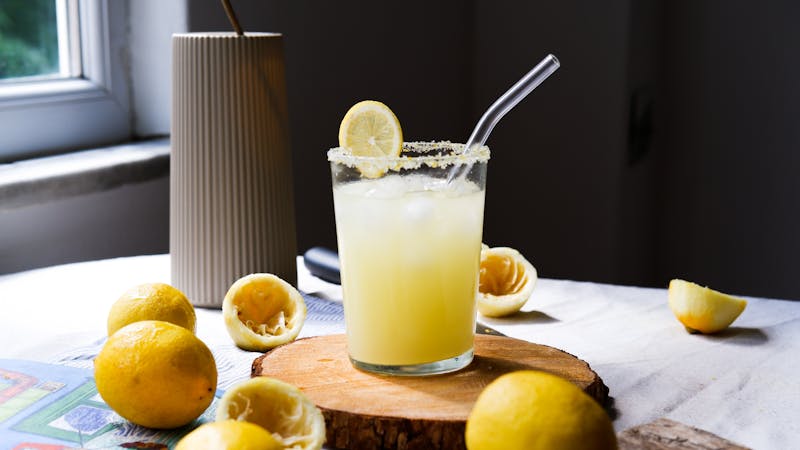 Craft lemonade with fresh lemons in a tall glass